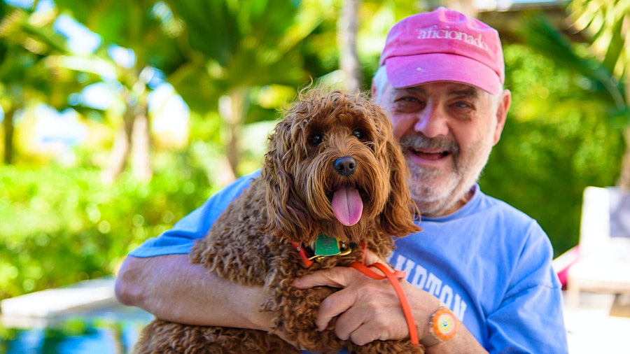Wine Spectator editor and publisher Marvin R. Shanken relaxes with Lionel, a Miniature Goldendoodle